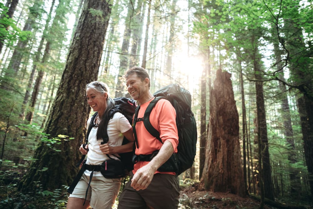 A couple on a hike near Newport Crossing Apartments in Newcastle, Washington