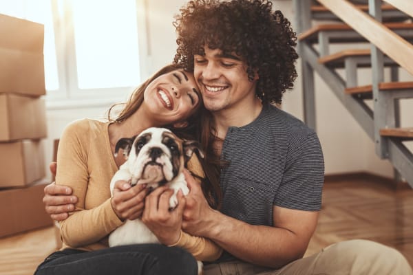 Family hugging their dog at Aviara at Mountain House in Mountain House, California