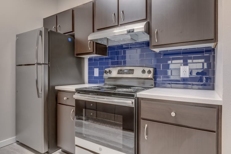 Fully equipped kitchen with stainless-steel appliances at Lumen Apartments in Everett, Washington