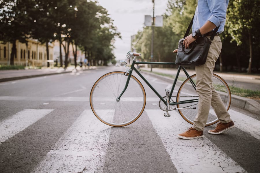 Man walking next to his bike near Alta Casa in Des Moines, Iowa