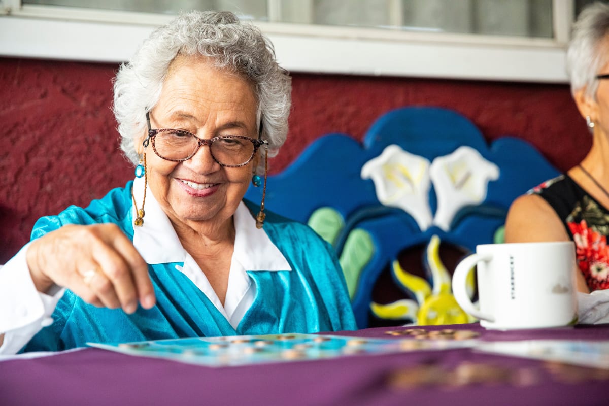 A Memory Care resident enjoying a board game at a Meridian Senior Living community