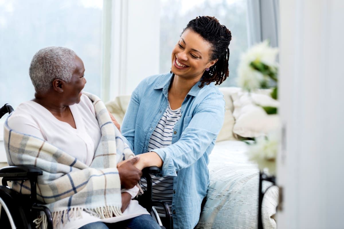 A staff member helping out a resident at Claiborne Senior Living