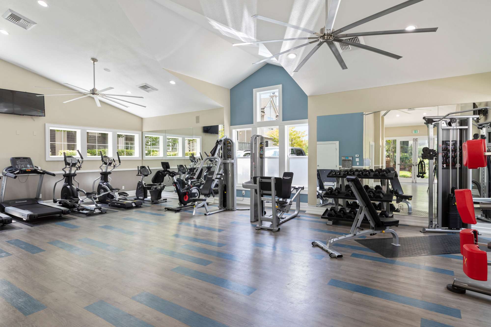 Fitness center with treadmill at HighGrove Apartments in Everett, Washington