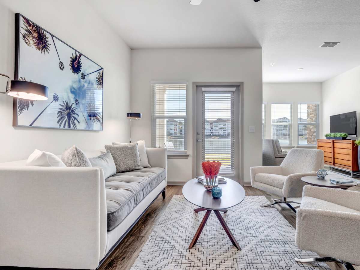 Model apartment with well-furnished living area at The Carlton of Fort Myers in Fort Myers, Florida