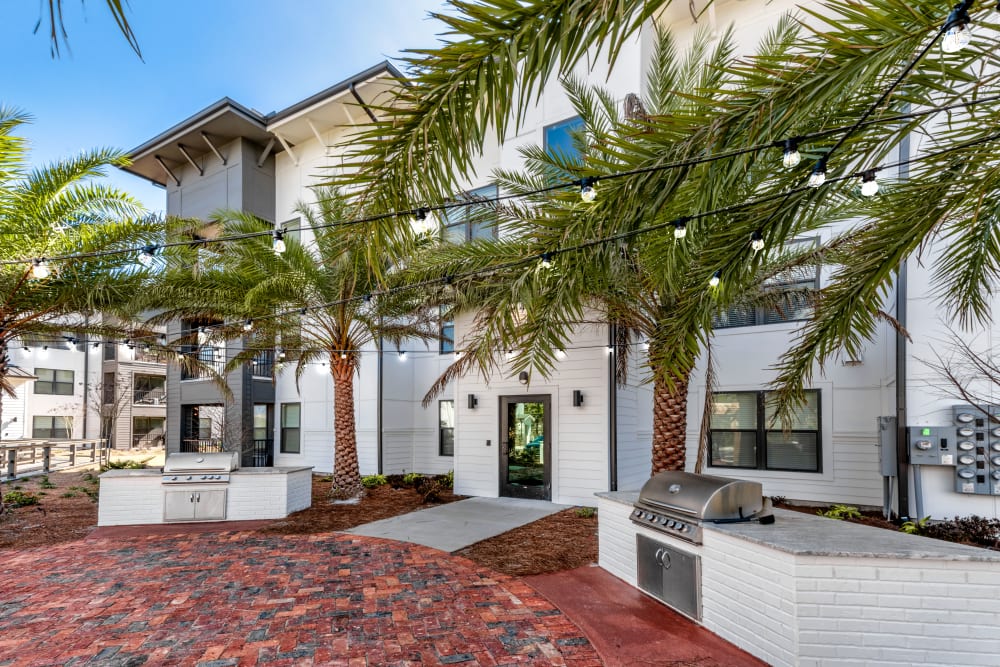 A poolside patio with BBQ stations at Olympus Emerald Coast in Destin, Florida