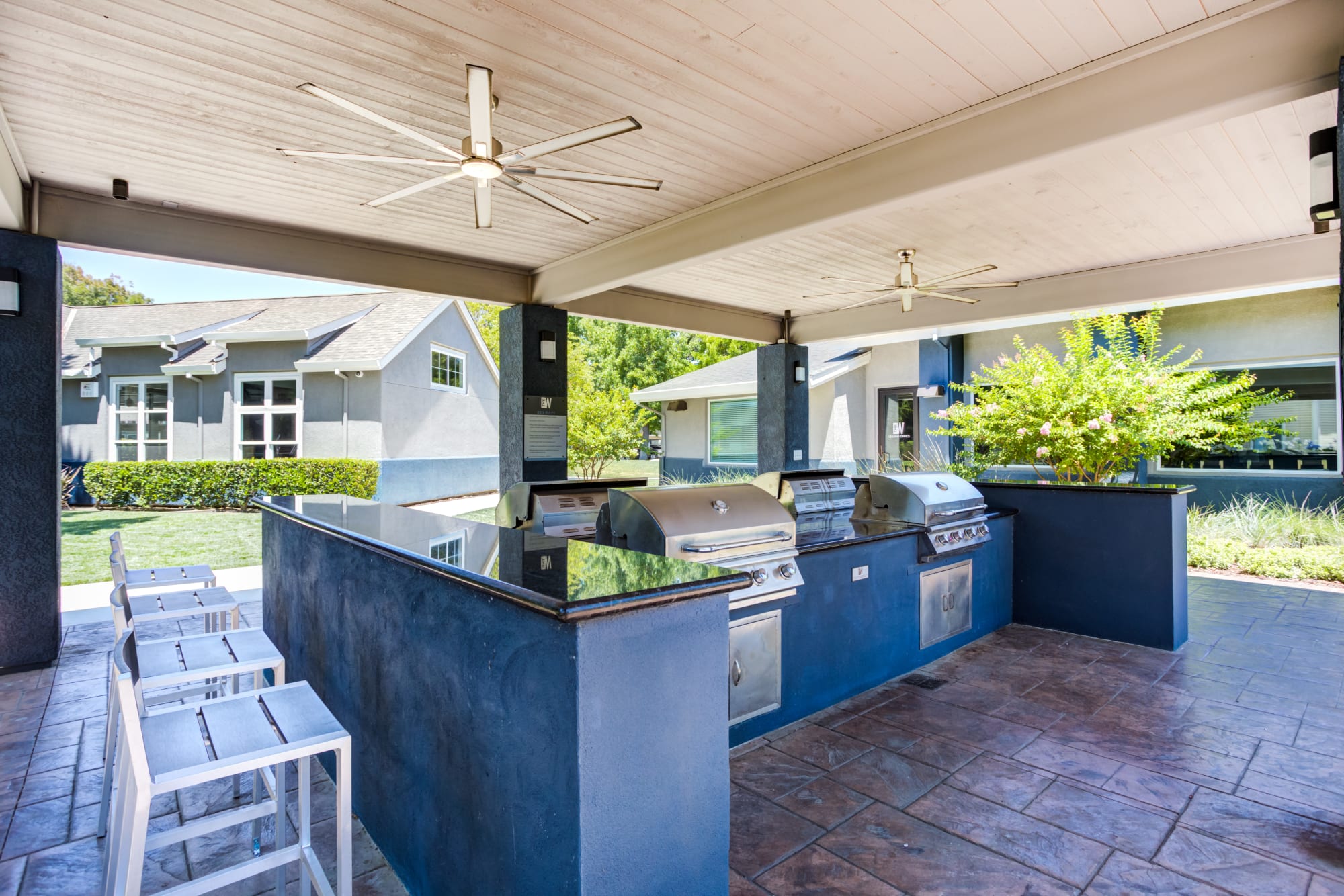 Covered outdoor BBQ area at The Woodlands Apartments in Sacramento, California