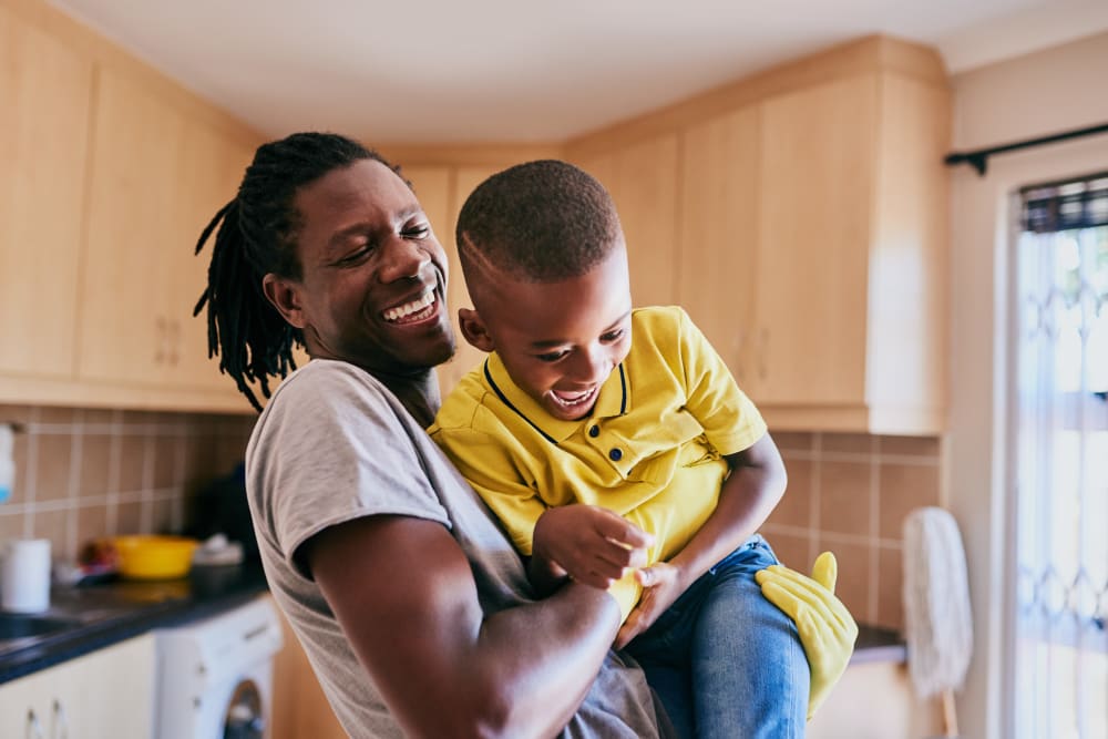 Resident joking around and playing with his son at Creekside Village in Alexandria, Virginia