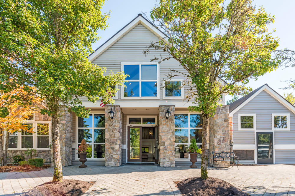 Leasing center entrance with two large trees at HighGrove Apartments in Everett, Washington