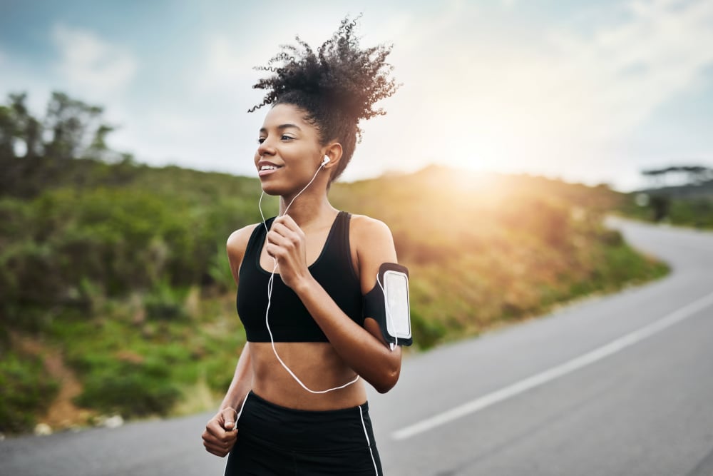 A woman on a jog near Alton Green Apartments in Denver, Colorado