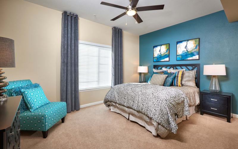 Large master bedroom with a ceiling fan at Skyecrest Apartments in Lakewood, Colorado