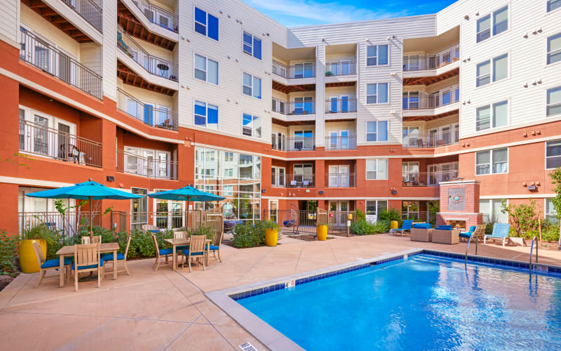 Large sparkling pool and lounge area at Helios in Englewood, Colorado