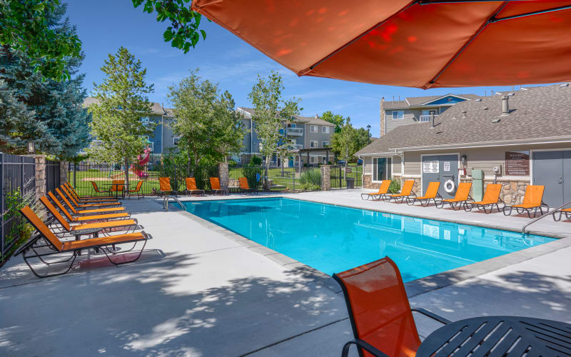 Covered seating near the swimming pool at Crossroads at City Center Apartments in Aurora, Colorado