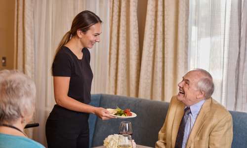 Resident being served lunch at Barclay House of Augusta in Augusta, Georgia