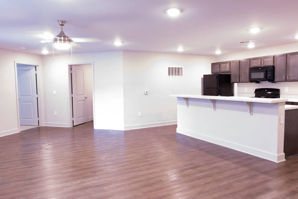 Unfurnished living room with view to kitchen at Villas At Mount Zion in Stockbridge, Georgia