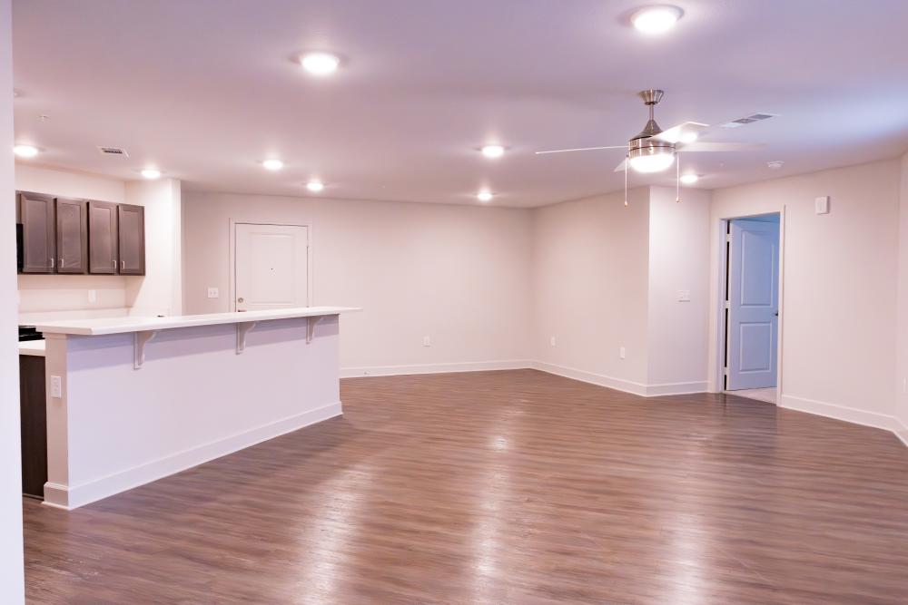 Unfurnished living room with ceiling fan and wood-style flooring at Villas At Mount Zion in Stockbridge, Georgia