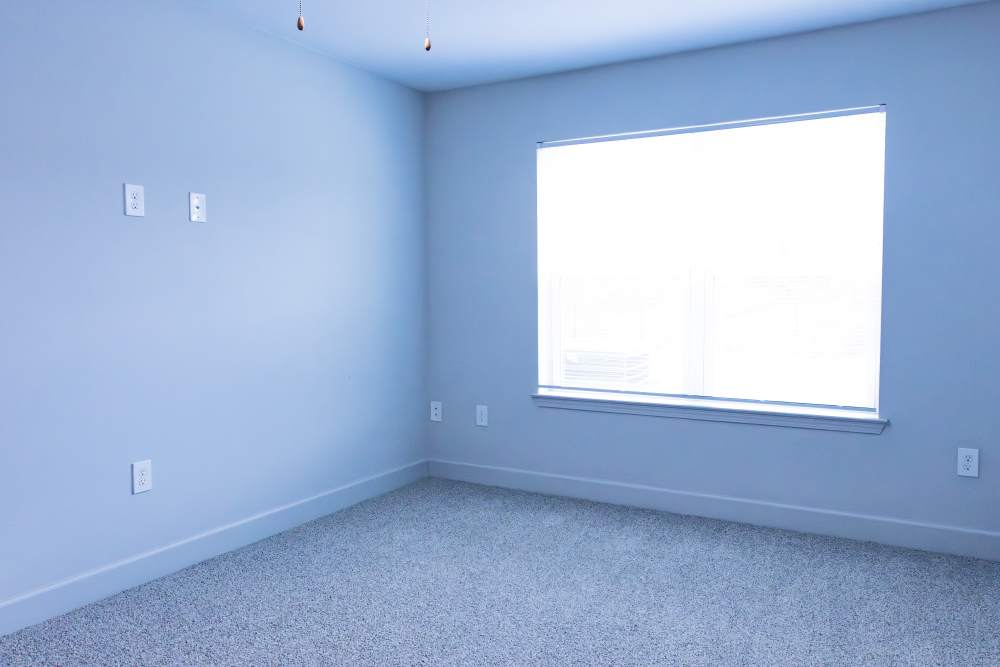 Unfurnished bedroom with large window at Villas At Mount Zion in Stockbridge, Georgia