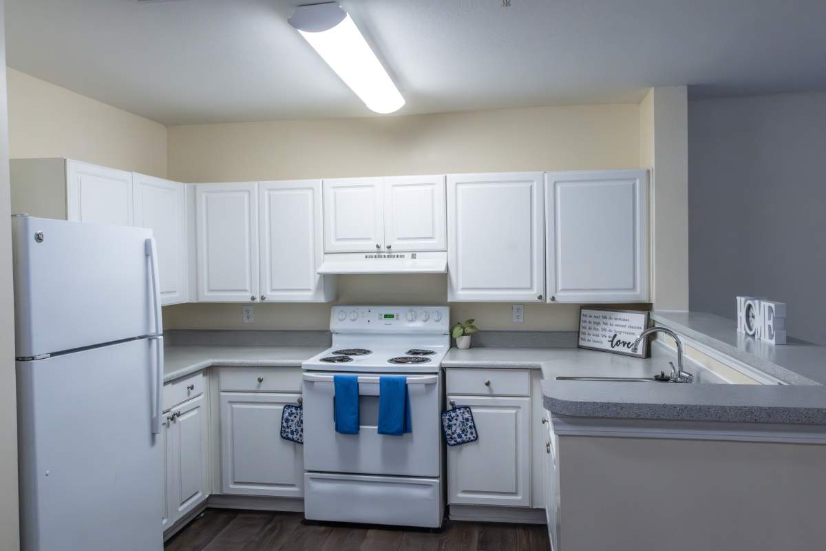  Kitchen with white appliances at Ashton Walk in Forest Park, Georgia