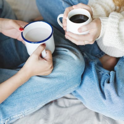 Roommates enjoying morning coffee together in their new apartment home at Haven Apartment Homes in Kent, Washington