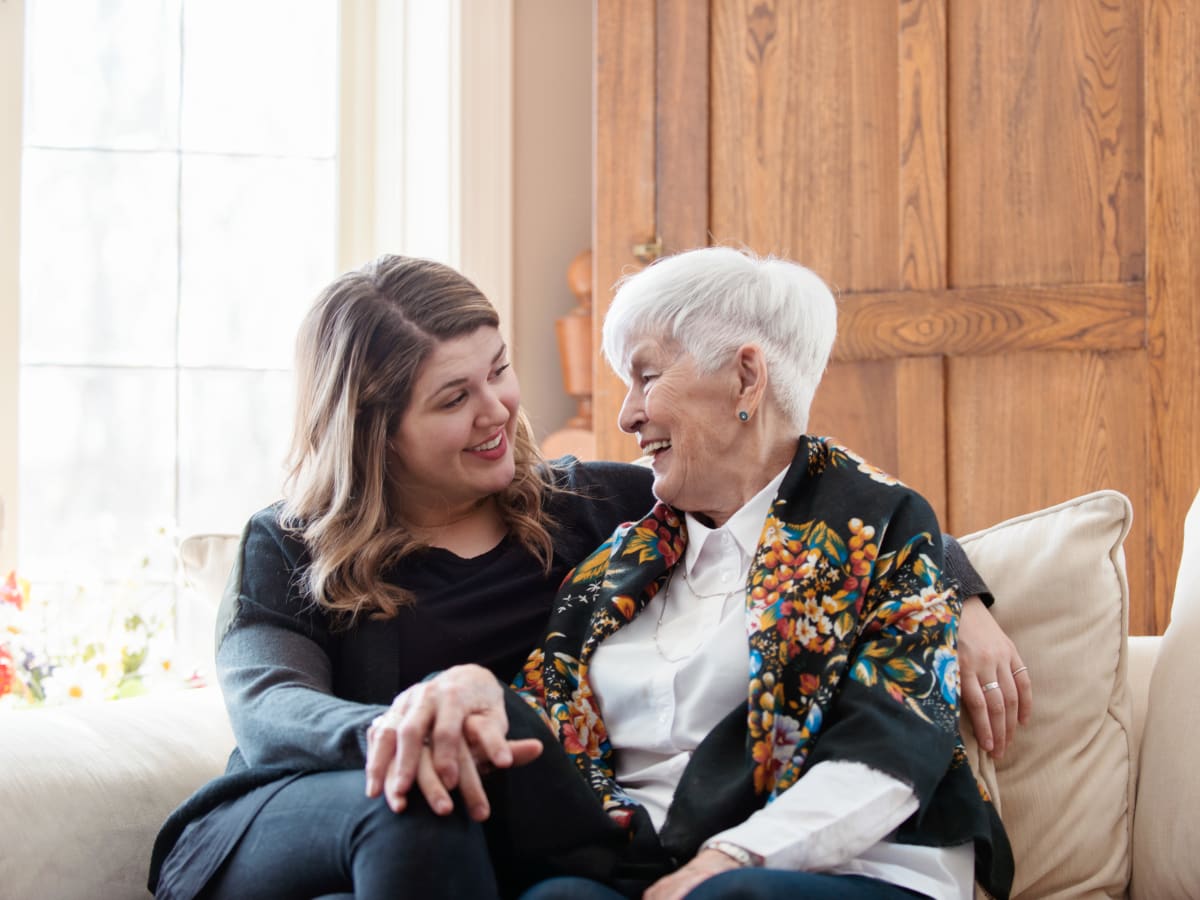 A resident and a younger family member embracing at Ativo Senior Living of Yuma in Yuma, Arizona.