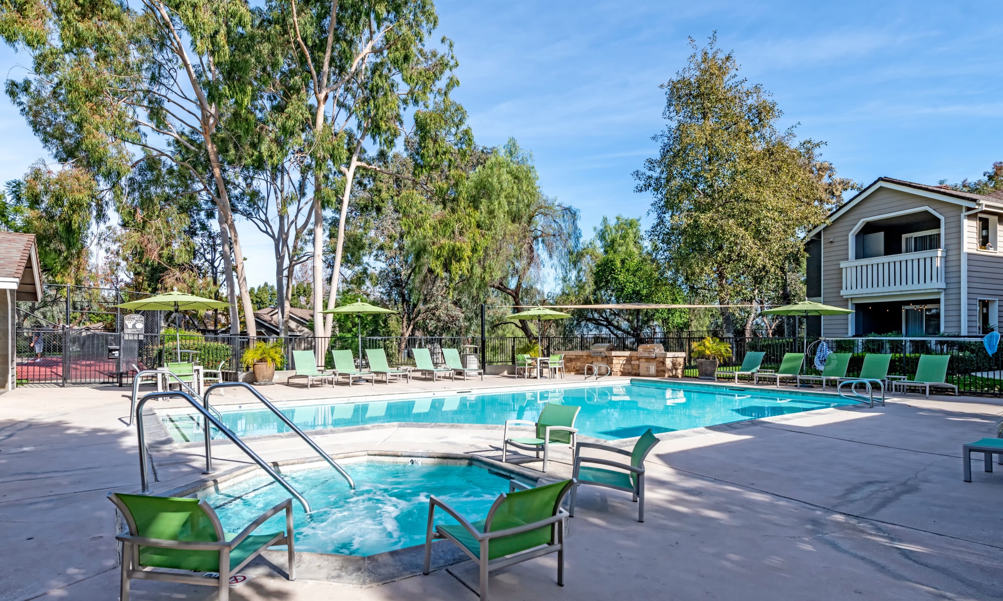 Beautiful pool/spa area with lounge chairs at sunset at Village Oaks in Chino Hills, CA
