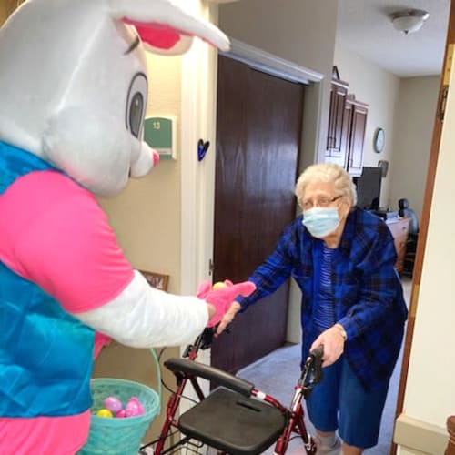 Resident being visited by the Easter Bunny delivering chocolate at Madison House in Norfolk, Nebraska