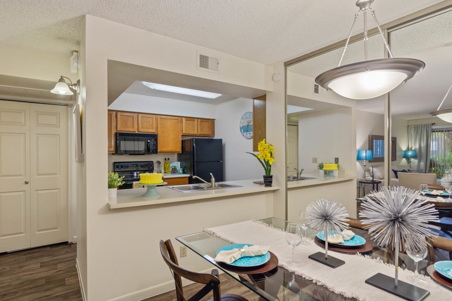 Open dining room and kitchen with breakfast bar at Waterford Place Apartments in Mesa, Arizona