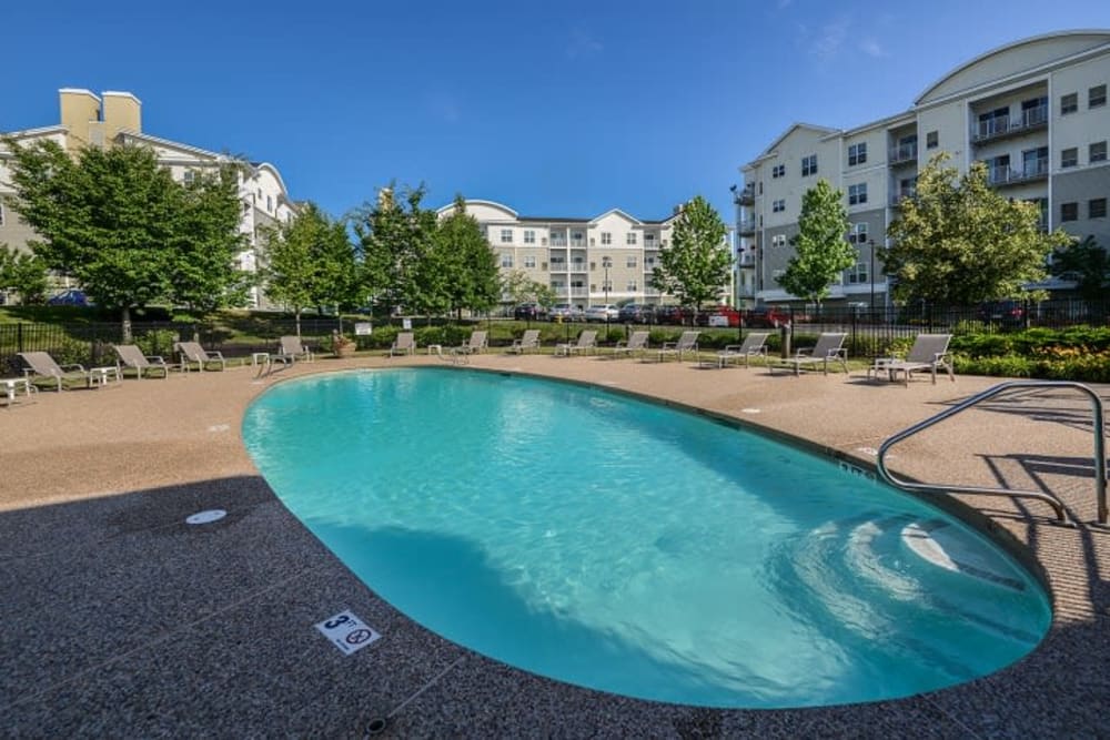 Large swimming pool surrounded by lounge chairs at Sofi Danvers in Danvers, Massachusetts