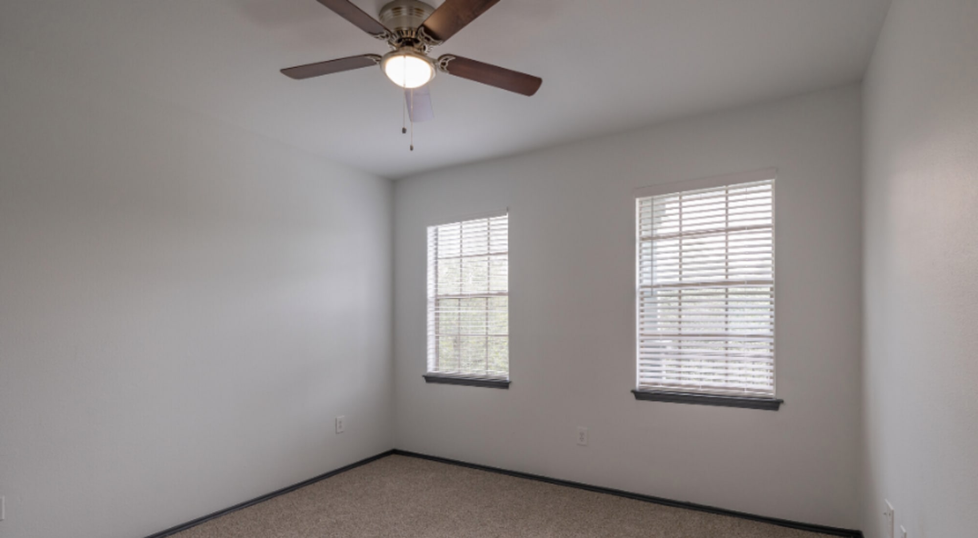 Bedroom with ceiling fan at Legacy at Cypress in Cypress, Texas