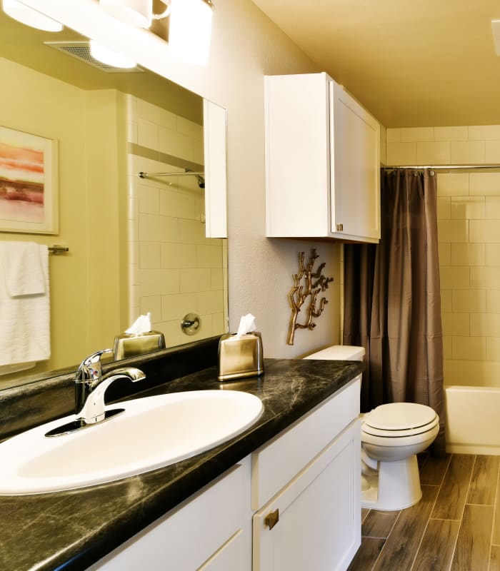 Bathroom with tile flooring at Cottages at Abbey Glen Apartments in Lubbock, Texas