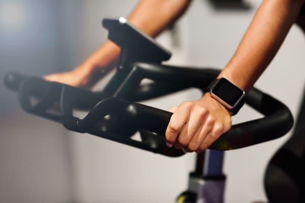 Woman riding an exercise bike in the gym at Fusion in Jacksonville, Florida