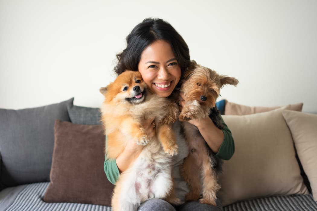 Resident hugging her two pets at Deane Hill