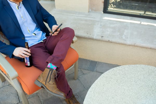 Resident relaxing at one of the outdoor common areas at The Reserve at Gilbert Towne Centre in Gilbert, Arizona