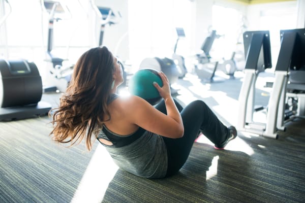 Resident working on her abs in the fitness center at San Marquis in Tempe, Arizona