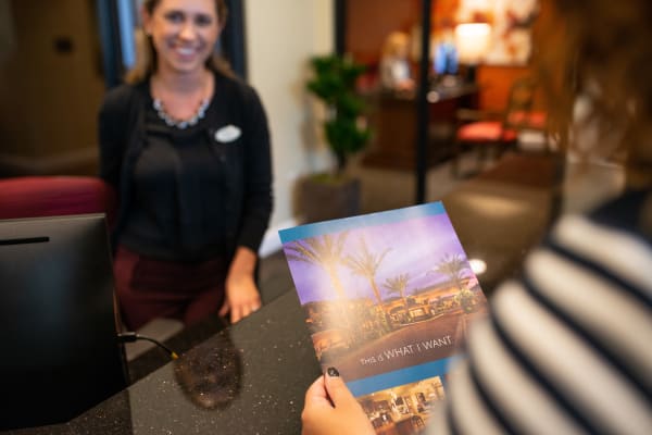 New resident picking up some community information in the leasing center at San Paseo in Phoenix, Arizona