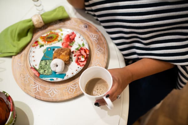 Resident a snack with her coffee at San Portales in Scottsdale, Arizona