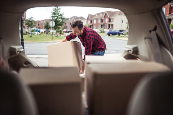 Young couple packing their SUV with home goods for a trip to YourSpace Storage @ Bayside in Frankford, Delaware