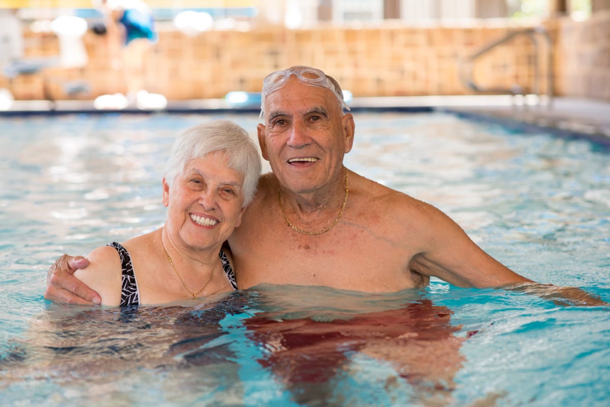 Couple enjoying the swimming pool at Watermere at the Preserve in North Richland Hills, Texas.