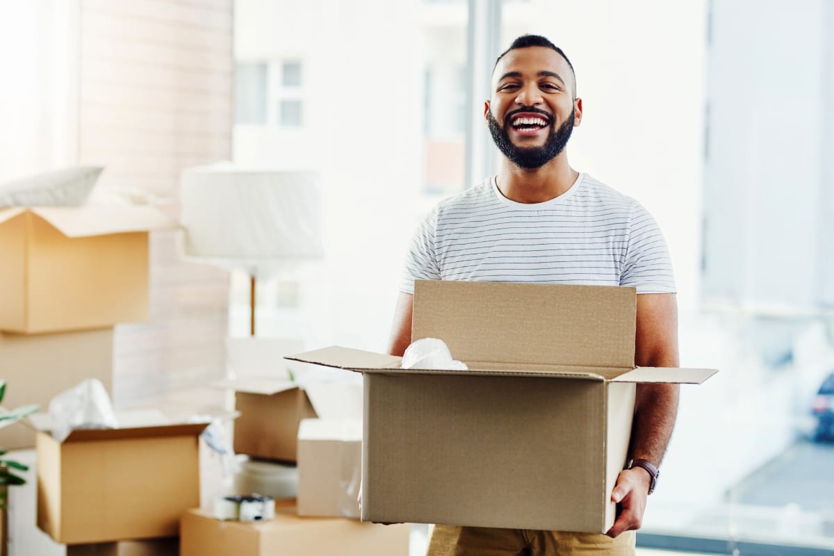 A man getting ready to move boxes to Extra Attic Mini Storage