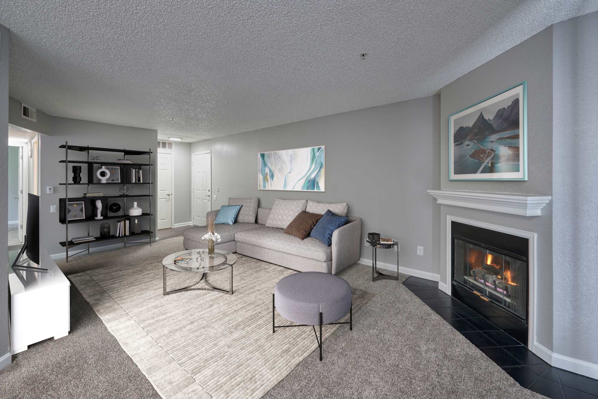 Living room with in-built fireplace at Arapahoe Club Apartments in Denver, Colorado