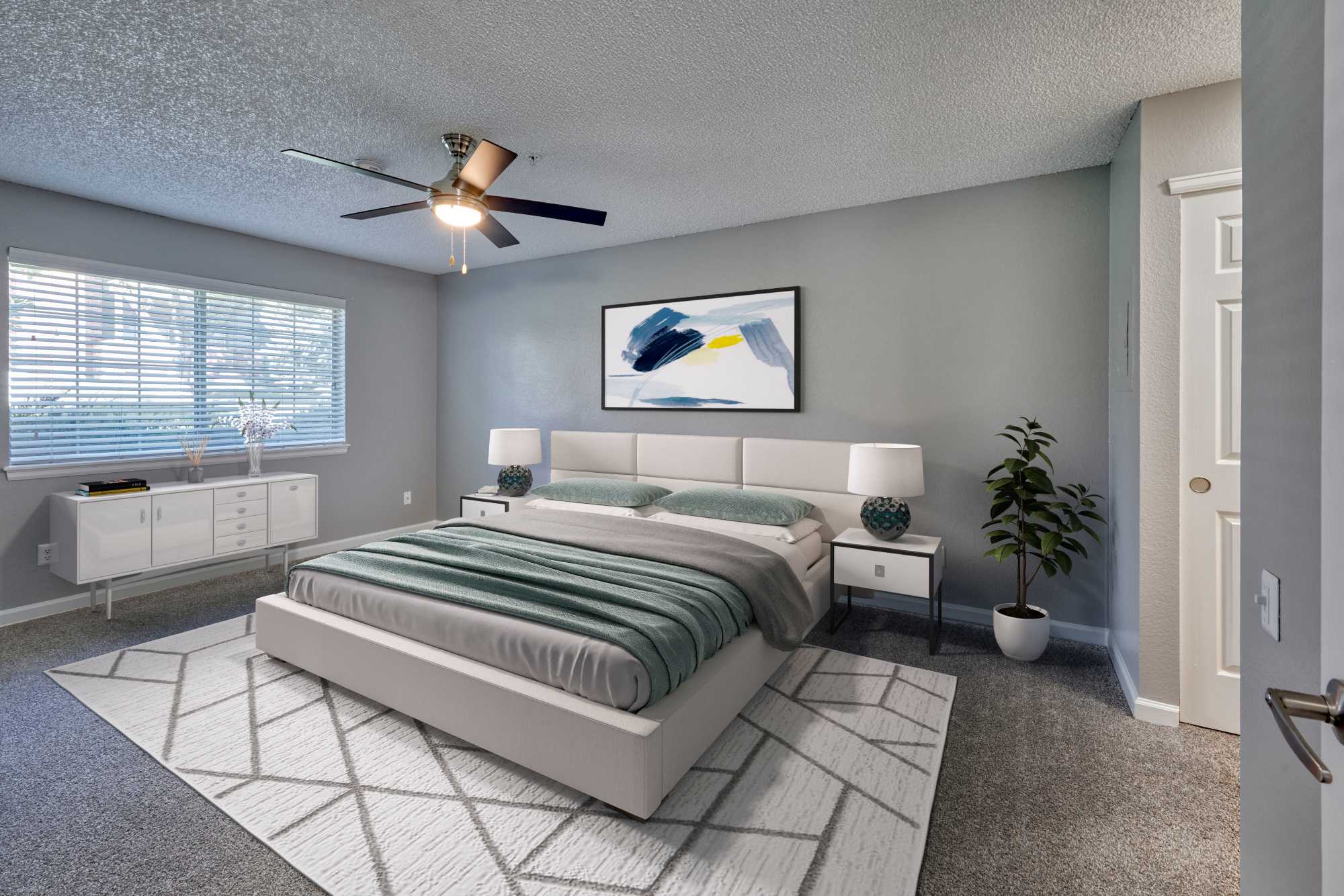 Well-furnished bedroom at Arapahoe Club Apartments in Denver, Colorado