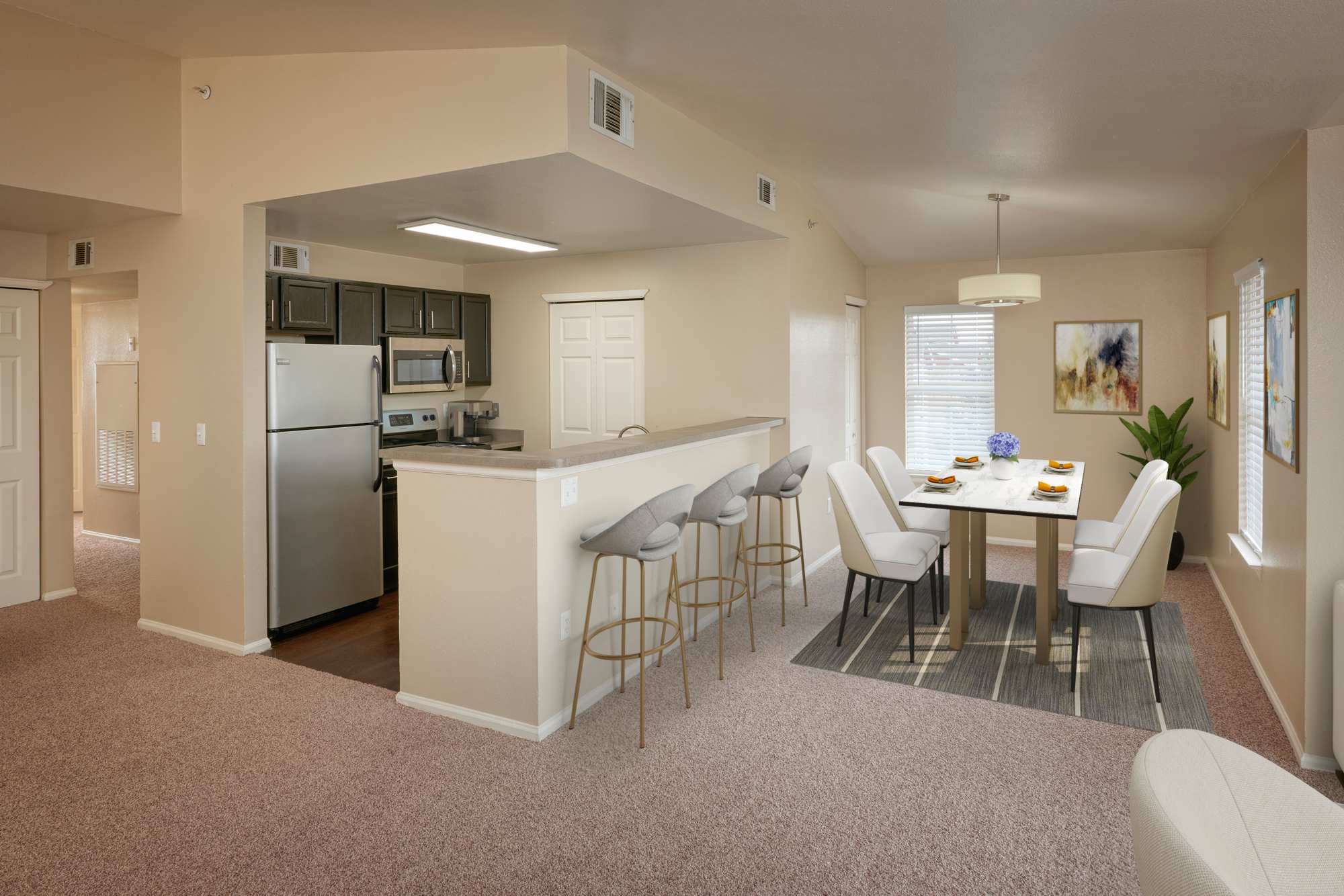 Kitchen with stainless-steel appliances and dining tale at Westridge Apartments in Aurora, Colorado