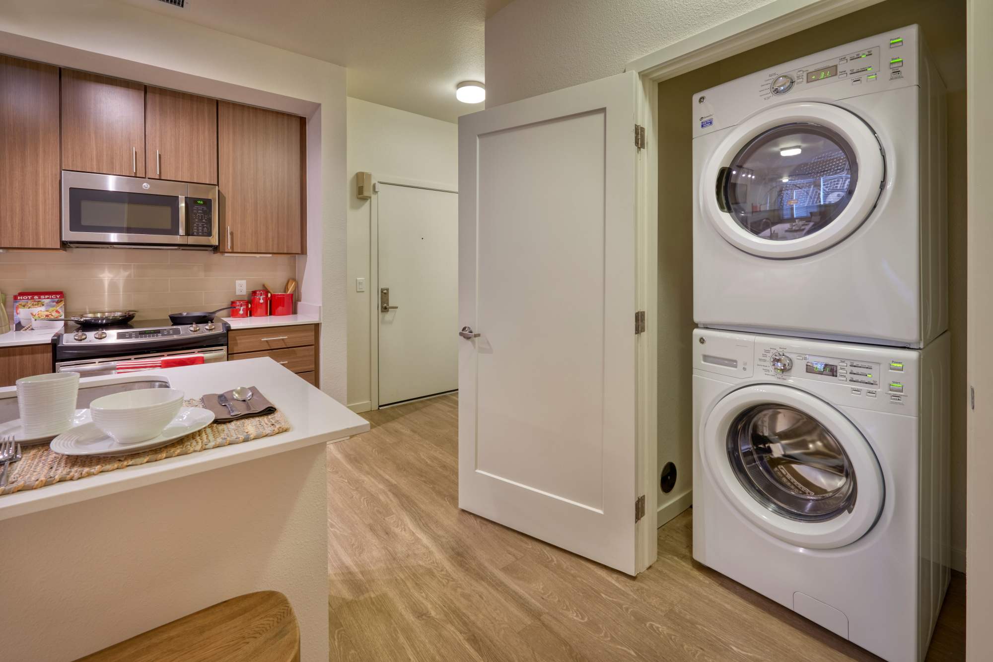 Laundry room with stackable washer and dryer at Elevate in Englewood, Colorado