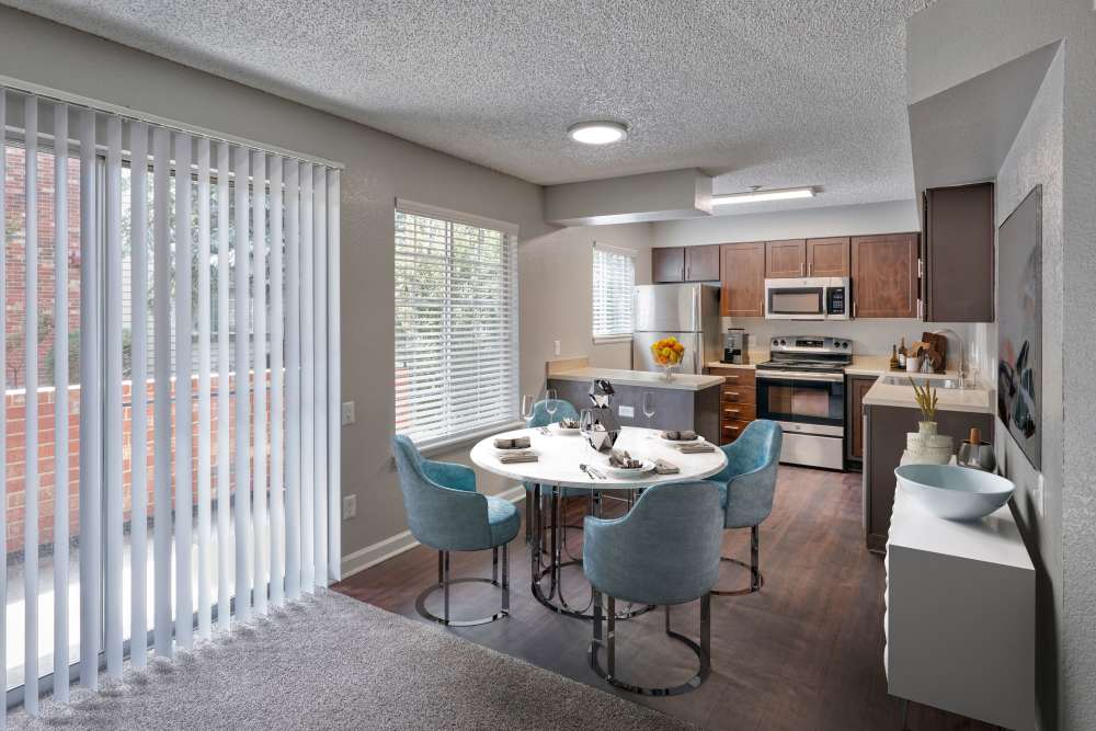 Modern kitchen with cozy dining area at Arapahoe Club Apartments in Denver, Colorado