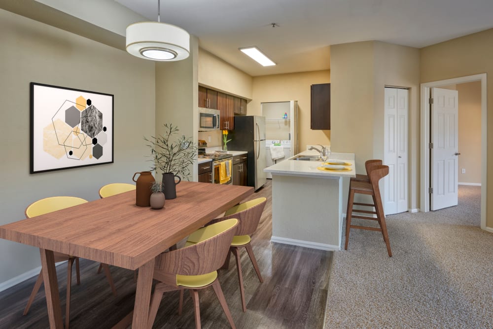 Dining room with wood-style flooring at The Crossings at Bear Creek Apartments in Lakewood, Colorado