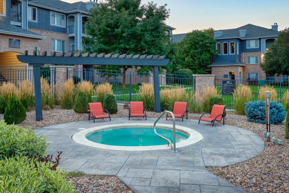 The relaxing hot tub and swimming pool at Hawthorne Hill Apartments in Thornton, Colorado