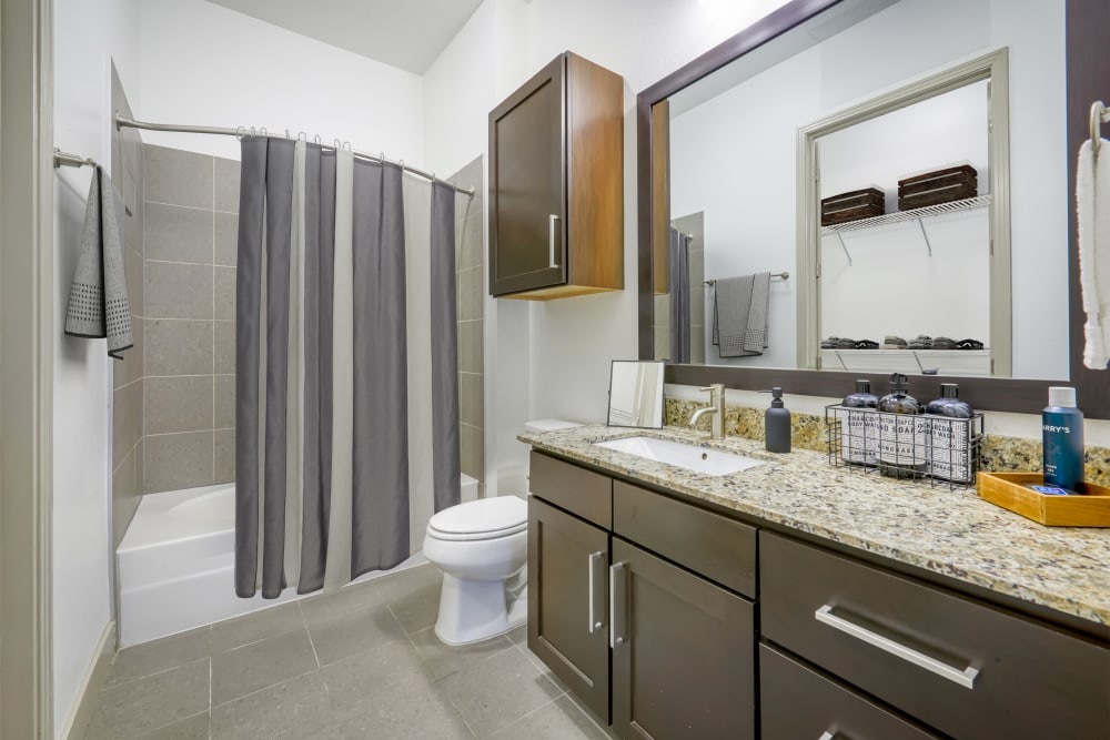 Spacious Bathroom with Brown Cabinets at Helios in Englewood, Colorado