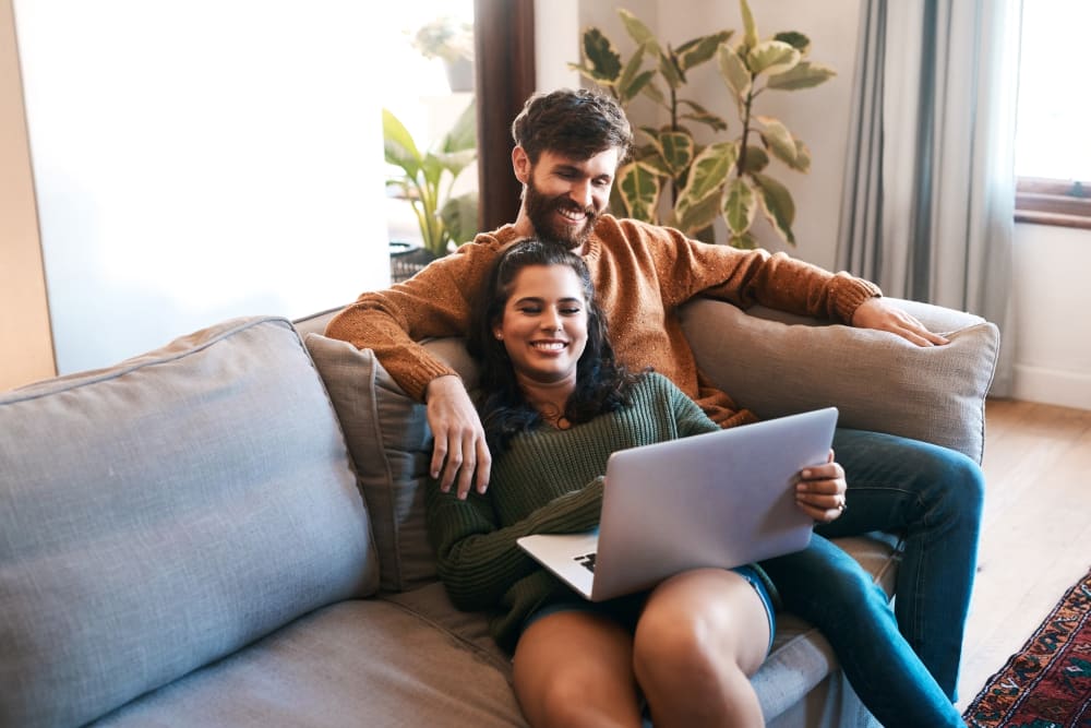 A happy couple relaxing at Bennington Apartments in Fairfield, California