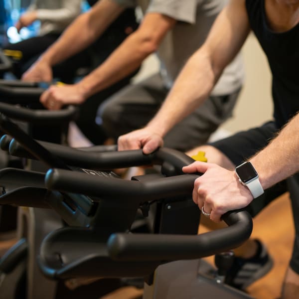 Man on a spin bike at the gym at Borrego at Spectrum in Gilbert, Arizona