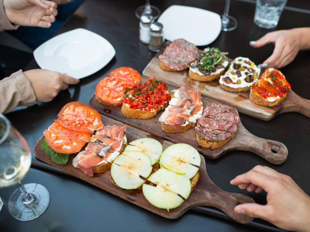 Resident enjoying flatbread appetizers near San Marbeya in Tempe, Arizona