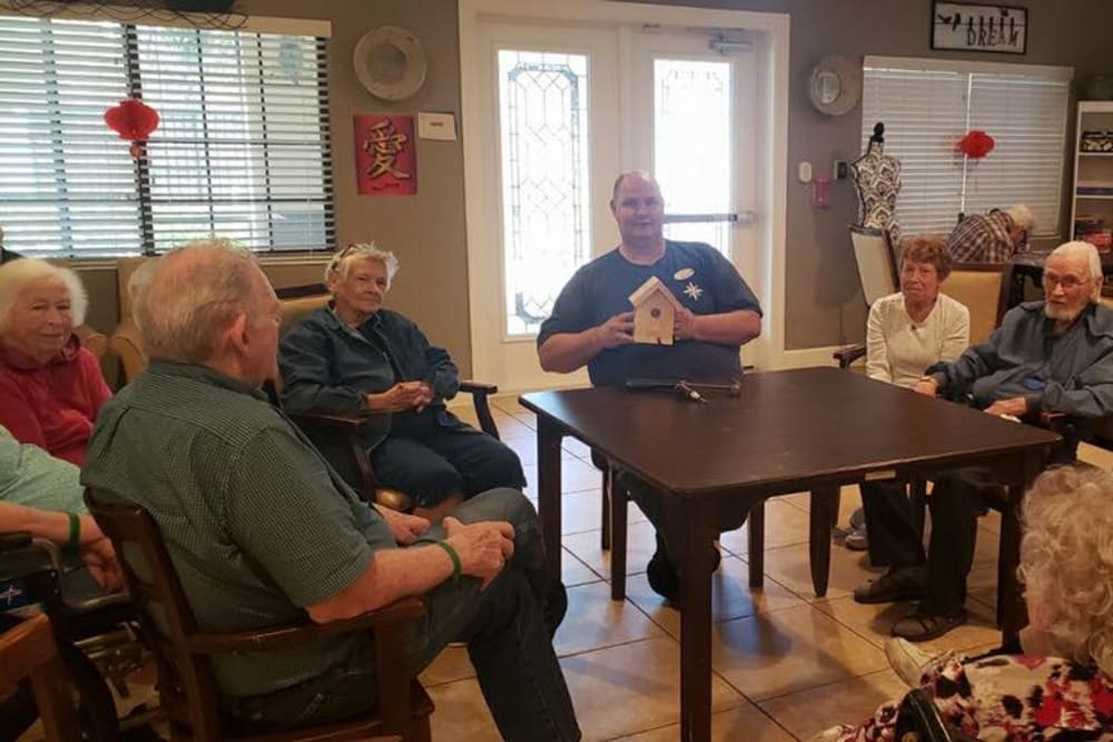 Residents making small birdhouses at Inspired Living Ivy Ridge in St Petersburg, Florida